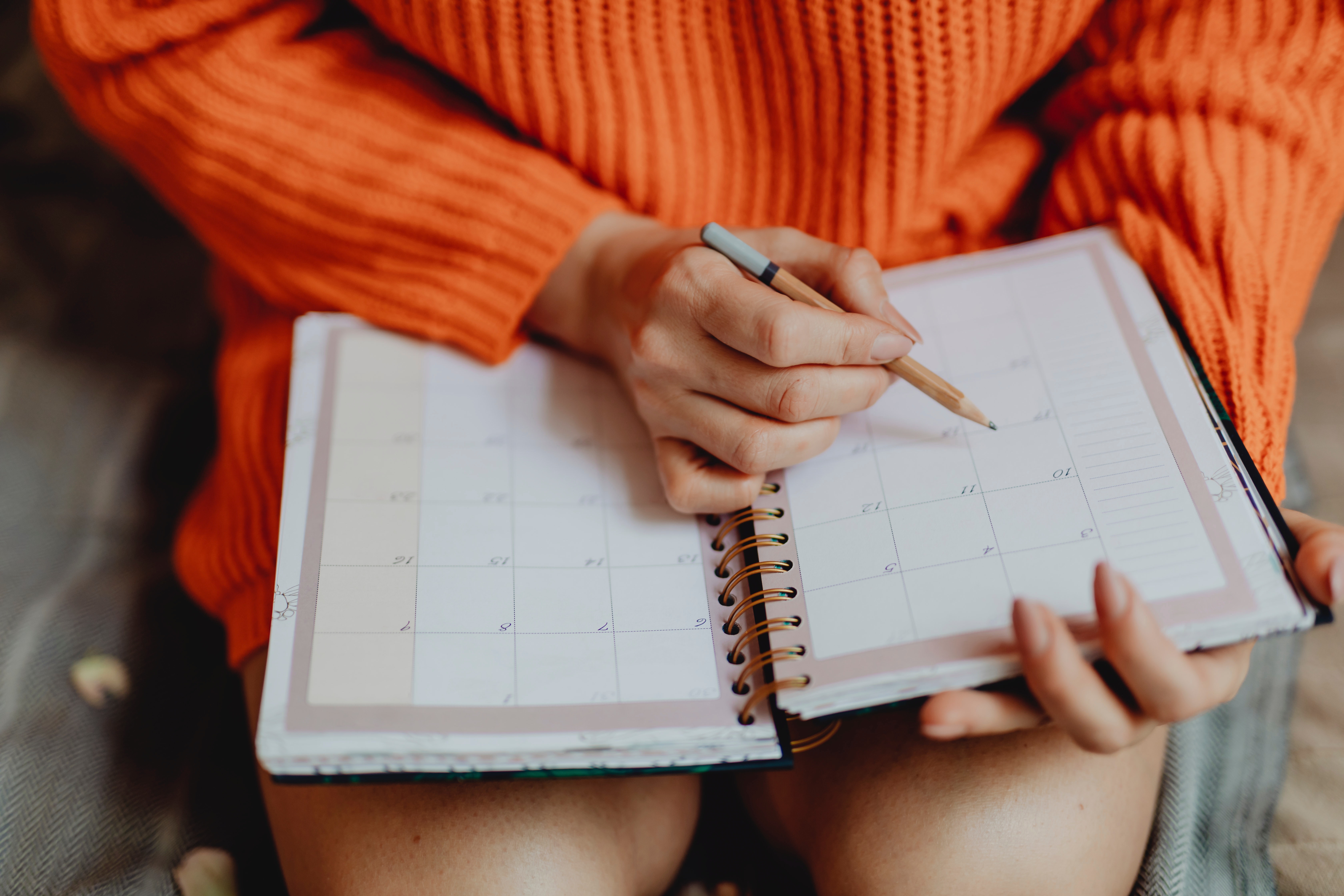 A woman writes down her study schedule so she can find a tutor with the same availability as hers