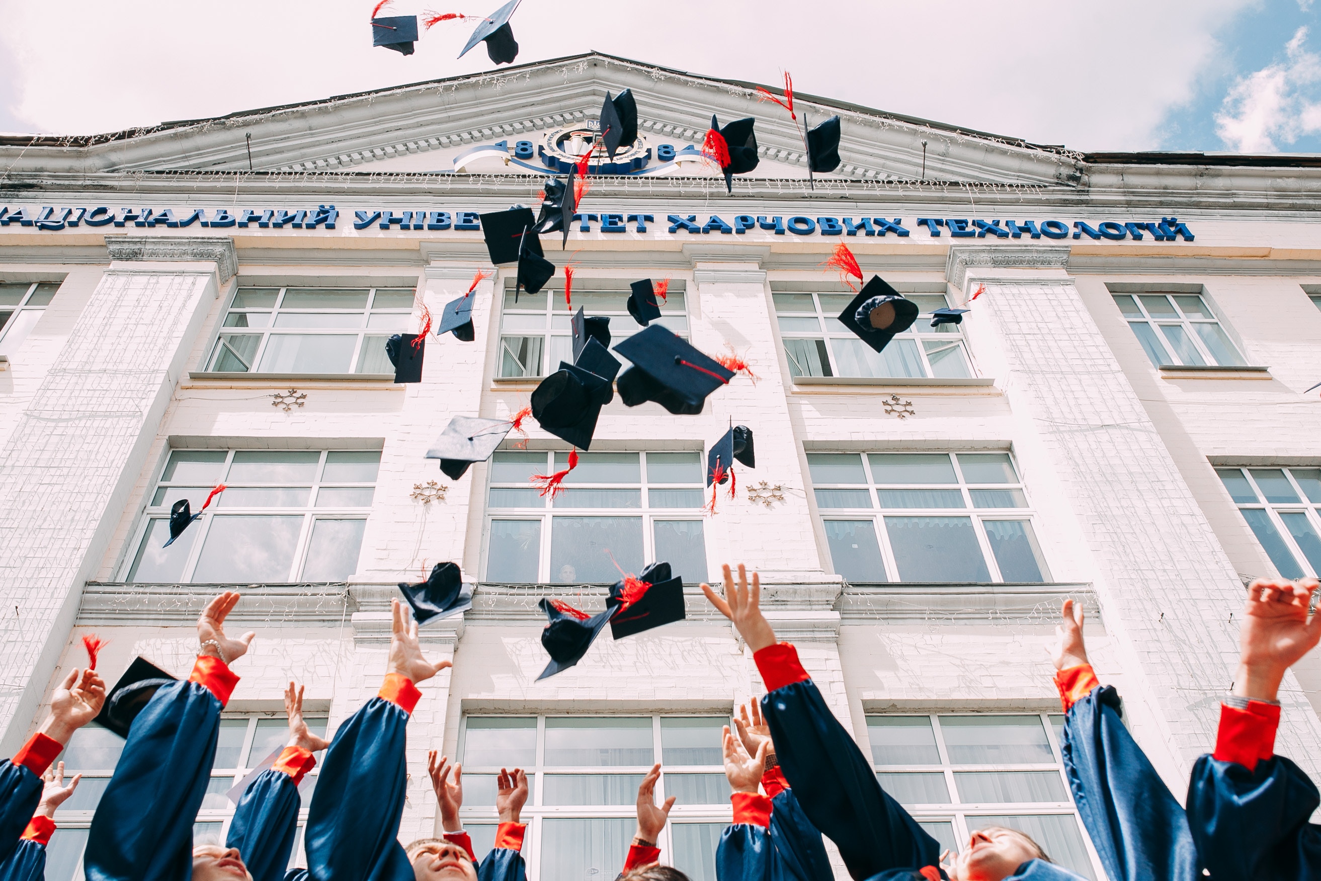 Students throw their graduation caps up in the air to celebrate their achievements